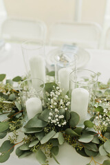Elegant wedding table with greenery and tall white candles