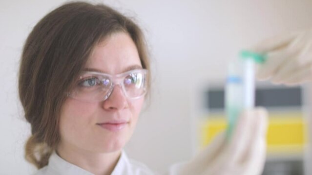 scientist female working with lab glasses and lab gloves