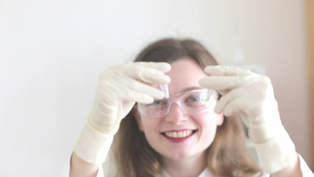 scientist female working with lab glasses and lab gloves