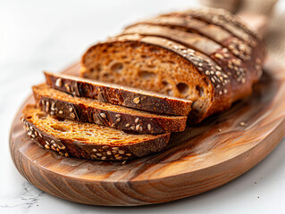 Sliced bread on a wooden cutting board. - obrazy, fototapety, plakaty