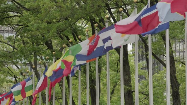 Line of national flags waving in front of the United Nations headquarters in New York City