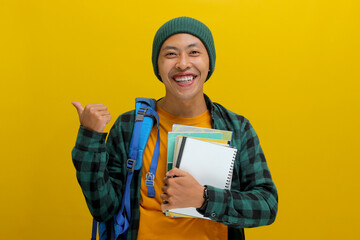 A young Asian student, dressed in a beanie hat and casual shirt and carrying a backpack, is...