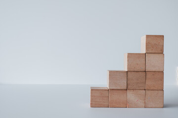 Ten Blank wooden cubes stack as stair shape on white background.