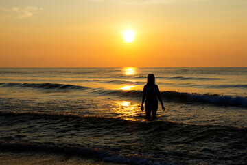 Woman body big with bikini and sunrise on beach