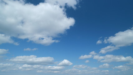 Blue sky cumulus and stratocumulus clouds. Scenic aerial background of blue sky with cumulus...