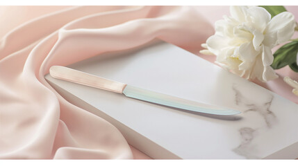 Stylish notebook and pen on silky fabric with elegant flowers