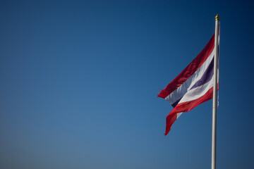 Flag of Thailand national against blue sky waving with pride colorful background