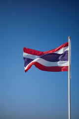 Flag of Thailand national against blue sky waving with pride colorful background