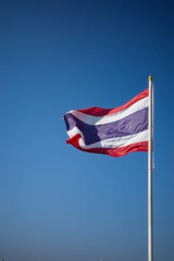 Flag of Thailand national against blue sky waving with pride colorful background