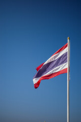 Flag of Thailand national against blue sky waving with pride colorful background