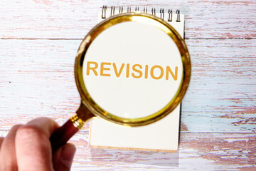 Business concept. REVISION word An inscription was found using a magnifying glass. Concept photo