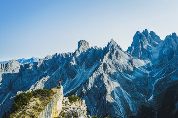Aerial view of a man with raised hands enjoying Cadini di Misurina mountain peaks, Italian Alps,...