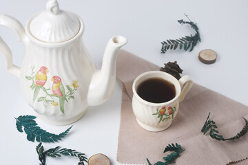 Sweet tea with a white cup and teapot with ceramic material