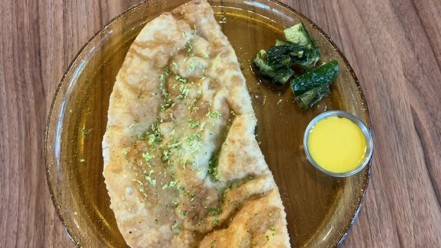 woman cooking homemade pasties frying chebureks in kitchen at home