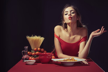 Sexy Woman bites sensually cooked spaghetti. Sensually twirling the noodles. Sensual aroma of the...