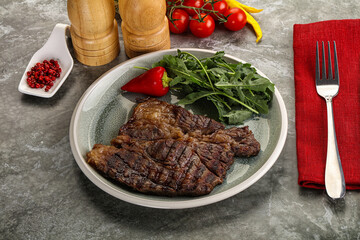 Grilled chuck roll steak with arugula