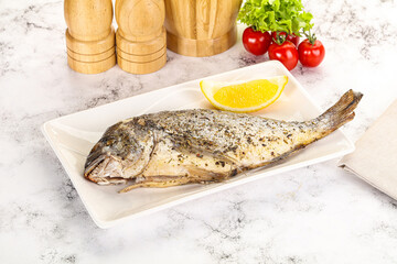 Baked Dorado fish served lemon