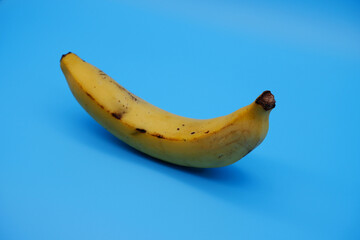 Banana with bright blue background. Fresh yellow banana, a healthy and organic fruit that is good...