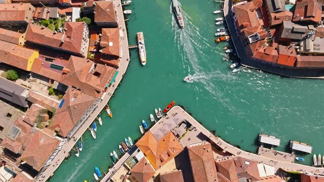 Boats moving on a canal in Murano, Venice, Italy