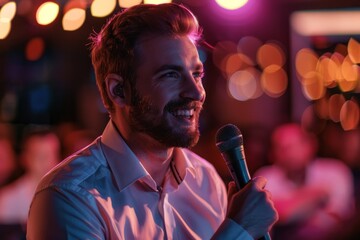 A man holding a microphone in his hand, engaging with the audience at a comedy club