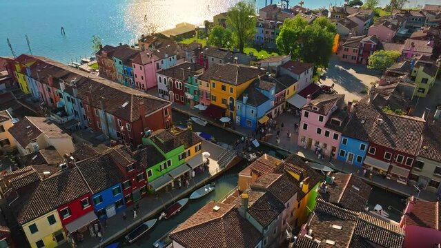 Aerial view of boats on the sides of a canal near the colourful houses of Burano Island, Italy