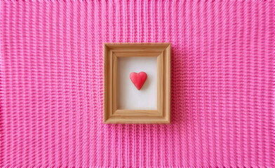 Heart-shaped cookie. Wooden Frame. Pink Knitted Background. Handmade still life. Handmade...