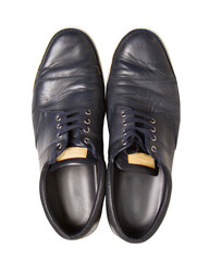 A pair of black leather shoes with laces on a white background, depicting fashion and apparel