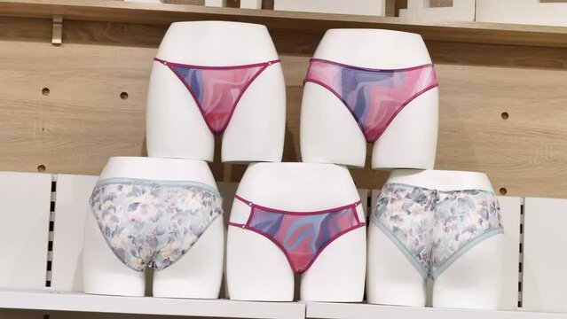Clothing shop. Women's swimwear. Swimming costumes worn on mannequins. How swimming costumes fit in the bikini area of girls. A clear example of panties worn on mannequins in the shop. 