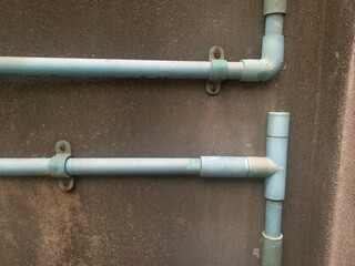 rusty plastic pvc pipe, water pipe on the ground, Blue plastic water pipes on gray cement...