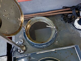 Metal stainless water barrel with an open lid and mesh for coarse water filtration in a fire truck....