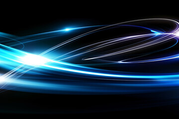 Abstract blue light trails against black background