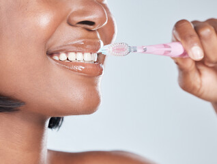 Black woman, closeup and mouth with toothbrush for dental hygiene on a white studio background. Young African, female person or model with smile in satisfaction for oral, gum care or morning routine