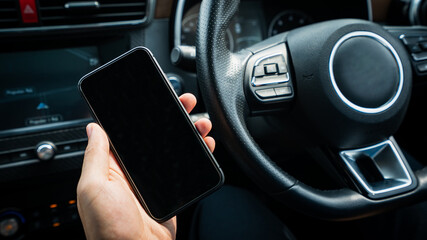 Man using his cellphone in a car. Reading an information on the phone screen. Phone screen mockup. 