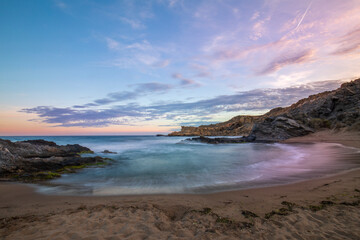 Sunset view of Minas Cove in the Cabo Cope and Puntas de Calnegre Regional Park, with crystal clear waters and colorful sky