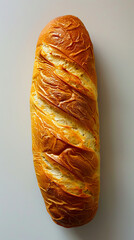 A loaf of bread on a white surface. - obrazy, fototapety, plakaty