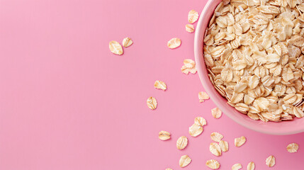 Raw oatmeal on pink background closeup