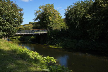Footbridge over a creek in the palace garden of Egeskov Castle near Kvaerndrup, island of Funen, Denmark, Europe
