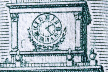 Macro image of clock on the one hundred US Dollar bill. Photo in high resolution.