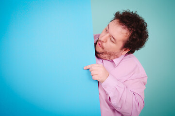 Business solutions. Anger, joy and aggression. Fat man posing on a blue background.