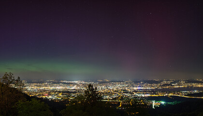 Fototapeta premium Large panorama of the city of Zurich in Switzerland from Uetliberg at night with northern lights