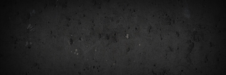 Texture of old concrete wall. Rough dark gray concrete surface with spots, cracks, noise and grain....