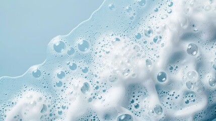 Lush white foam on a blue background, the structure of soap bubbles. Abstract background.