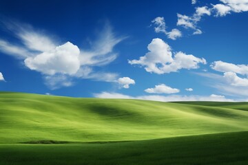 Fototapeta premium A beautiful summer or spring landscape with green grass on the hills and green fields. The blue sky is filled with white clouds and bright sunlight. Nature as a background.
