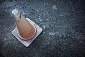 pylon traffic cone damaged old  dirty on the concrete background concept