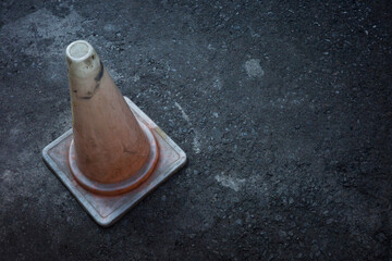 pylon traffic cone damaged old  dirty on the concrete background concept
