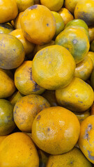 Close up pile of tasty fresh oranges sold at the market as a background.