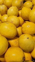 Close up pile of tasty fresh limes sold at the market as a background.