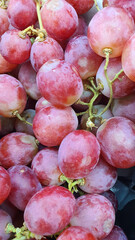 Close up pile of tasty fresh grapes sold at the market as a background.