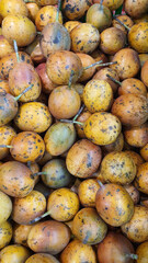 Close up pile of fresh passion fruits placed together in local market as a background.	