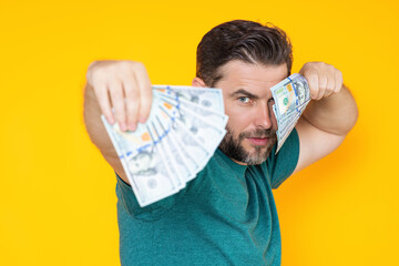 Rich man holding cash dollar bills on yellow studio. Big luck, banner. Dollar cash money concept....